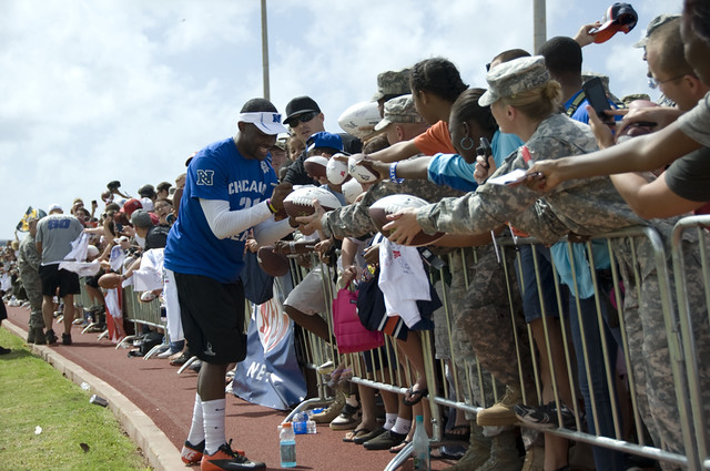 National Football League athletes sign autographs for military members and their families