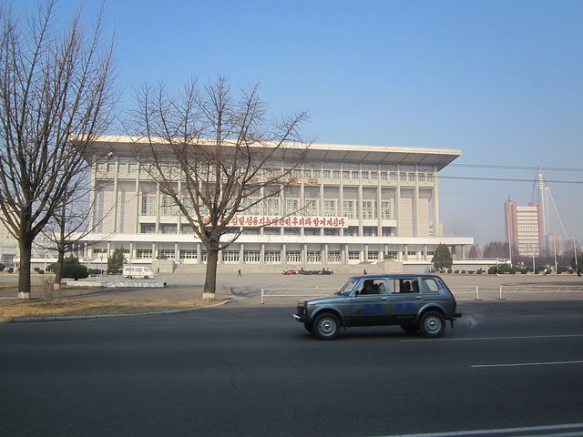 NORTH KOREA Pyongyang traffic safety vehicle in front of gymnasium building