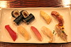 Top Left: Gourd Strip Roll (Kampyo-maki), Sea eel (Anago), Seared Golden eye snapper (Kinme-dai), Bottom Left: BLUEFIN TUNA (Akami), Japanese scallop (Tairagai), Yellowtail (warasa), Surf clam (Aoyagi), and Spanish mackerel (Aji)