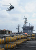 A helicopter approaches the flight deck of USS George H.W. Bush.