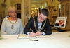 The Mayor of Belfast, Councillor Niall Ó Donnghaile signing the book