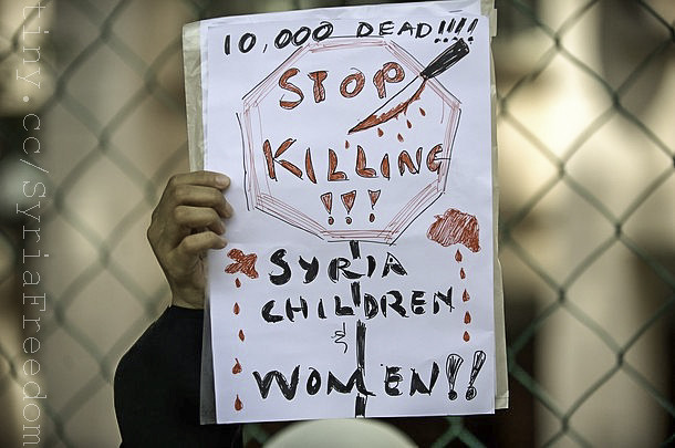 A Syrian national displays a placard during a protest rally against Syrian President Bashar al-Assads regime in Kuala Lumpur on March 16, 2012.
