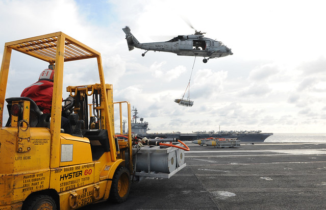 A helicopter lifts off the deck of USS George H.W. Bush.
