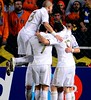 Real Madrids players celebrate after French forward Karim BENZEMA scored his teams first goal against APOEL during their UEFA Champions League first leg quarter-final football match at GSP Stadium in Nicosia on March 27, 2012. AFP PHOTO / PIERRE-PHILIPP