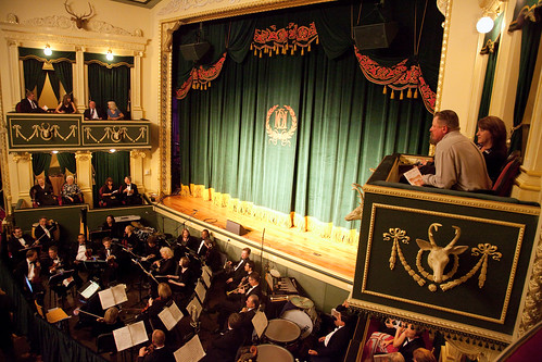 people watching orchestra from balcony seat