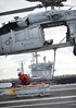 A helicopter lifts off the deck of USS George H.W. Bush. during a vertical replenishment.