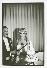 Example of obligatory wedding album photo - Bride and groom cutting cake