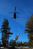 California Army National Guard Chinook crew works with multi-service recovery team to slingload a downed Navy helicopter from high mountain training area
