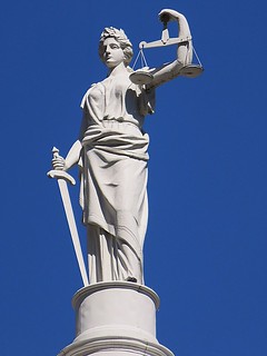 From http://www.flickr.com/photos/59958425@N04/13313869395/: Statue of Justice atop New York City Hall, 260 Broadway, New York City. This statue is a rarity in that here Justice is not wearing a blindfold.