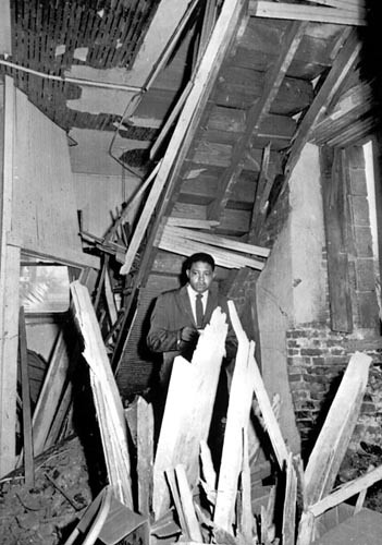 The Rev. John H. Cross of the Sixteenth Street Baptist Church stands amid the wreckage of the bulding after it was bombed in September 1963. Four young girls died in the blast.
