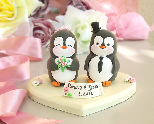 Penguin wedding cake topper with wood base and banner
