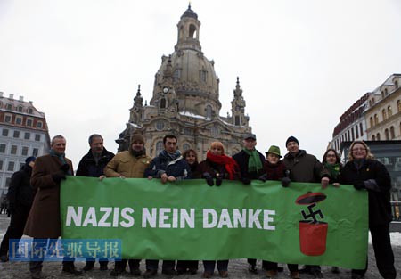 Members of Germanys Green Party stand in front of the Frauenkirche (Church of Our Lady) in Dresden to protest against an Ultra-right activists march through the city