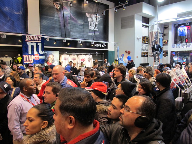 Crowds in Modells Times Square watch as Giants players MARIO MANNINGHAM and Dave Tollefson participate in photo ops, 02/06/12 (IMG_6323)
