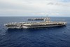 USS Dwight D. Eisenhower participates in an ammunition on-load with USS George H. W. Bush.