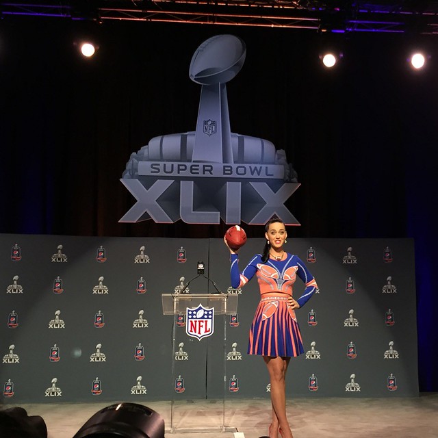 Singer Katy Perry tosses a football at a Super Bowl XLIX press conference. Perry is the Super Bowl halftime performer.