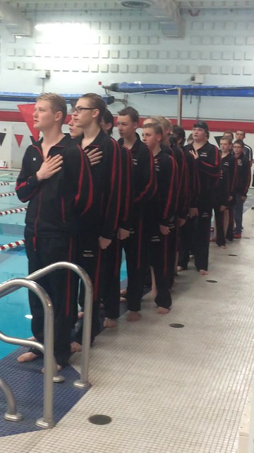 Swim team leading the National Anthem before the dual swim meet on February 3, 2015.