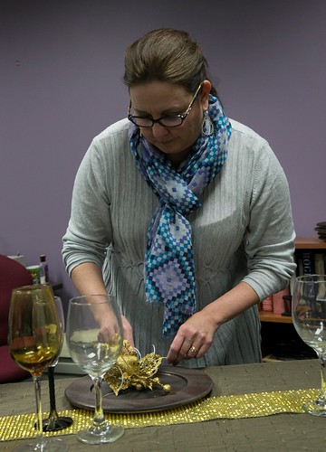 Prof. Catherine Anderson preps a sample place setting.