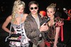 Zac Efron is ultra-serious as a retro cop with a big gun as he poses with duo Aly & AJ, both in racy costumes.