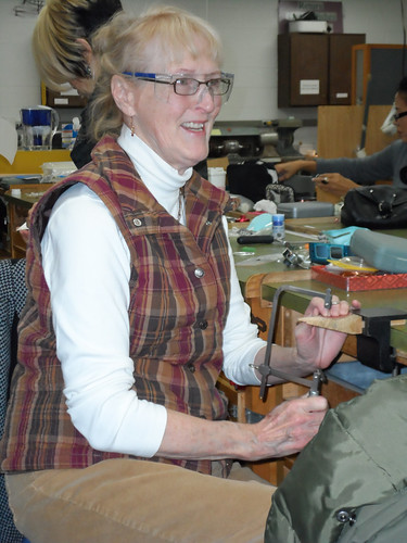 Reni Tracy smiles as she works on a piece of jewelry at Joliet Junior College.