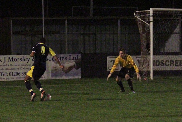 Ben runs onto a ball in the Needham, penalty area .
