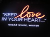 Keep Love In Your Hear quote from writer Oscar Wilde on the monitors in Times Square New York City