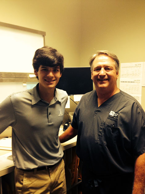 Carl Upton, Class of 2015, interning with Dr. Greg Wood, Class of 1976, at New South Neurospine