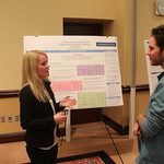 A student presents her capstone poster.