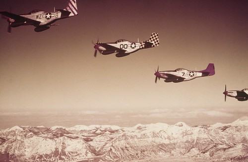 North American P-51 Mustangs of the 31st Fighter Group 325th Fighter Group and 332nd Fighter Group 15th Air Force fly in formation during a mission. ©  Robert Sullivan