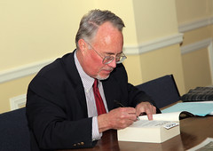 Signing his book, Bearing the Cross