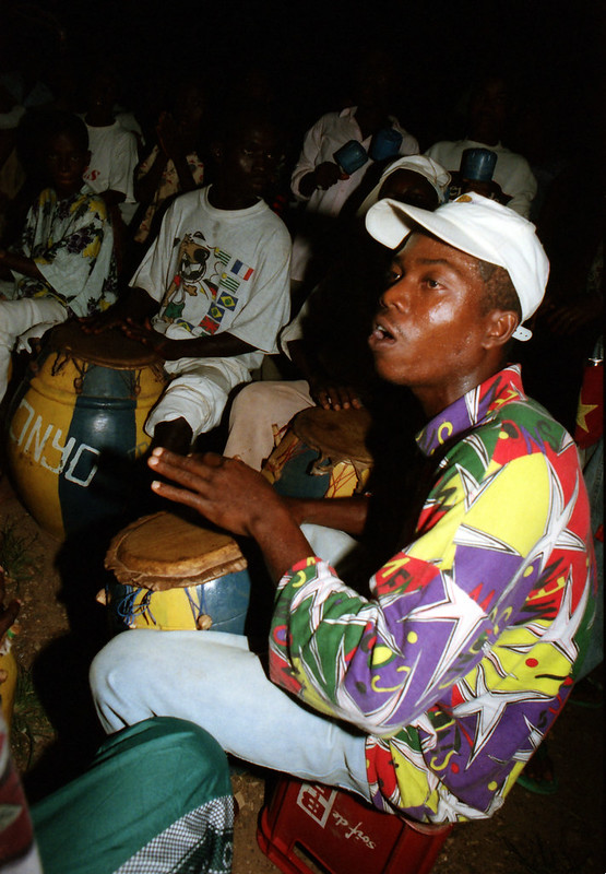 Togo West Africa Ethnic Cultural Dancing and Drumming African Village close to Palimé formerly known as Kpalimé a city in Plateaux Region Togo near the Ghanaian border 24 April 1999 146 Drumming<br/>© <a href="https://flickr.com/people/41087279@N00" target="_blank" rel="nofollow">41087279@N00</a> (<a href="https://flickr.com/photo.gne?id=13987571235" target="_blank" rel="nofollow">Flickr</a>)