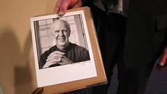 Doug Knutson holding his portrait of Parker Palmer.
