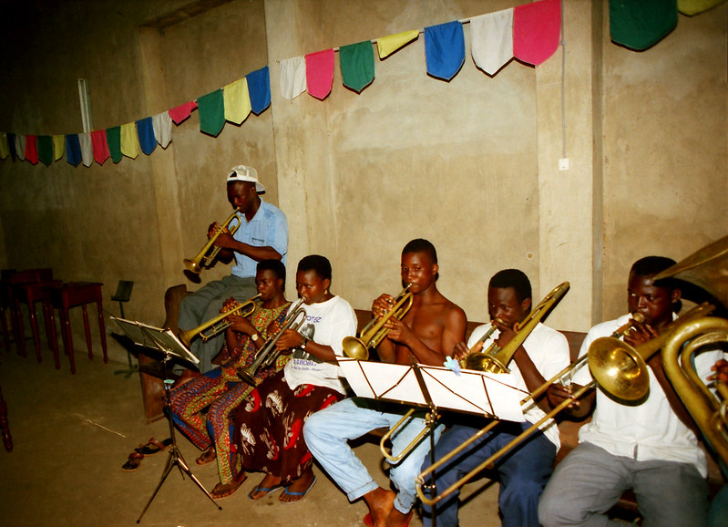Togo West Africa Local Ethnic Cultural Orchestra Band and Show African Village close to Palimé formerly known as Kpalimé a city in Plateaux Region Togo near the Ghanaian border 23 April 1999 045 Local Brass Band<br/>© <a href="https://flickr.com/people/41087279@N00" target="_blank" rel="nofollow">41087279@N00</a> (<a href="https://flickr.com/photo.gne?id=13929977563" target="_blank" rel="nofollow">Flickr</a>)