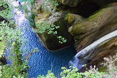 Waterfall of blue waters in the Urederra river Fountainhead. Cascada de aguas azules en el nacedero  del rio Urederra