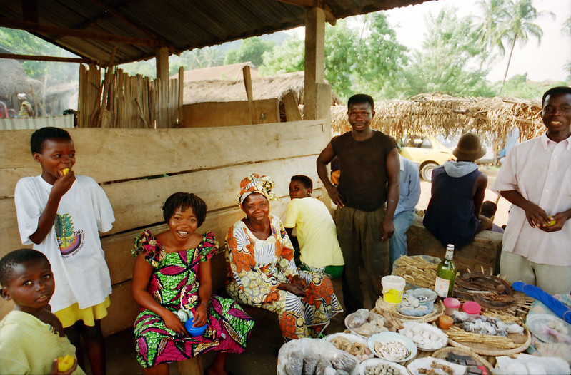Togo West Africa Village Market Togolese ladies close to Palimé formerly known as Kpalimé a city in Plateaux Region Togo near the Ghanaian border 24 April 1999 092<br/>© <a href="https://flickr.com/people/41087279@N00" target="_blank" rel="nofollow">41087279@N00</a> (<a href="https://flickr.com/photo.gne?id=13923016736" target="_blank" rel="nofollow">Flickr</a>)