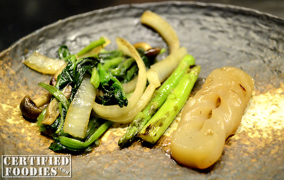 A plate of fresh onions, shiitake mushrooms, spinach, asparagus, and Konyaku (vegetable jelly) prepared teppanyaki style