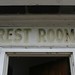 Faded vintage rest rooms sign on cabana
