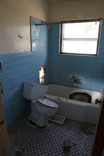 Blue tiled bathroom in bad shape