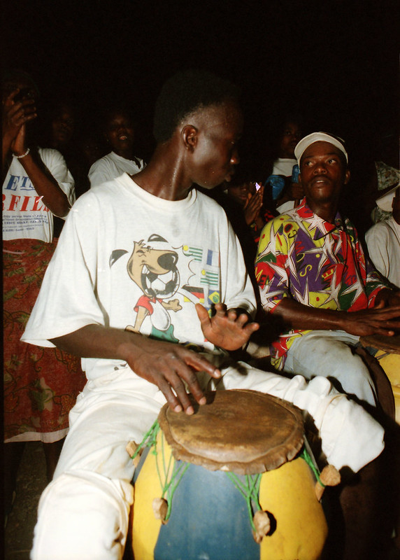 Togo West Africa Ethnic Cultural Dancing and Drumming African Village close to Palimé formerly known as Kpalimé a city in Plateaux Region Togo near the Ghanaian border 24 April 1999 157 Drumming<br/>© <a href="https://flickr.com/people/41087279@N00" target="_blank" rel="nofollow">41087279@N00</a> (<a href="https://flickr.com/photo.gne?id=13964454606" target="_blank" rel="nofollow">Flickr</a>)