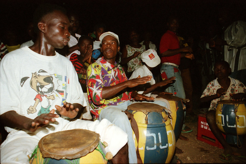 Togo West Africa Ethnic Cultural Dancing and Drumming African Village close to Palimé formerly known as Kpalimé a city in Plateaux Region Togo near the Ghanaian border 24 April 1999 156 Drumming<br/>© <a href="https://flickr.com/people/41087279@N00" target="_blank" rel="nofollow">41087279@N00</a> (<a href="https://flickr.com/photo.gne?id=13984393471" target="_blank" rel="nofollow">Flickr</a>)