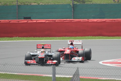 Fernando Alonso in his Ferrari racing with Lewis Hamilton in his McLaren at the 2012 British Grand Prix at Silverstone