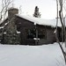 Log house with dark stained timber and big windows, stone fireplace, snow,  South Addition, Anchorage, Alaska