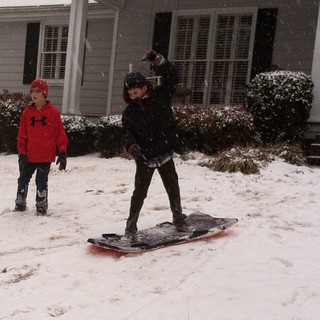 Ian's first "home snow" ever, and first time ever on a sled!