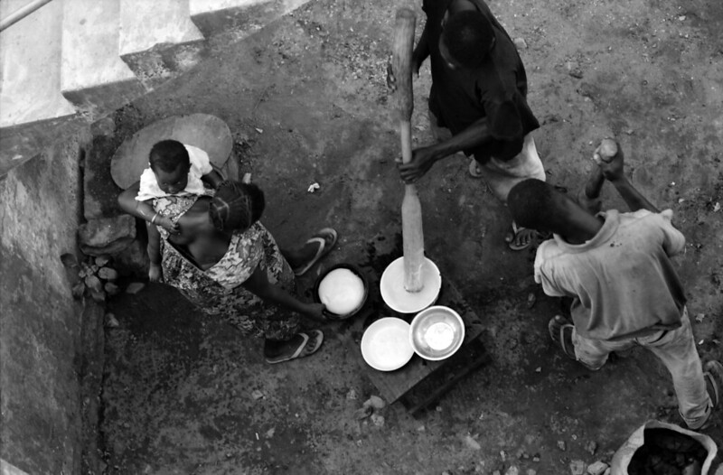 Togo West Africa Fufu Pounding Boiled Yams or Cassava Preparation Village close to Palimé formerly known as Kpalimé is a city in Plateaux Region Togo near the Ghanaian border B&W 23 April 1999 072 Fufu Preparation<br/>© <a href="https://flickr.com/people/41087279@N00" target="_blank" rel="nofollow">41087279@N00</a> (<a href="https://flickr.com/photo.gne?id=13923699546" target="_blank" rel="nofollow">Flickr</a>)