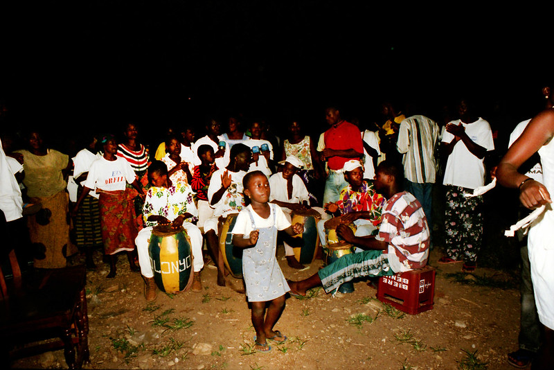 Togo West Africa Ethnic Cultural Dancing and Drumming African Village close to Palimé formerly known as Kpalimé a city in Plateaux Region Togo near the Ghanaian border 24 April 1999 148 Drumming<br/>© <a href="https://flickr.com/people/41087279@N00" target="_blank" rel="nofollow">41087279@N00</a> (<a href="https://flickr.com/photo.gne?id=13988007884" target="_blank" rel="nofollow">Flickr</a>)