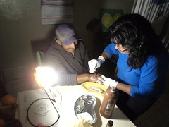 Sun King Pro illuminates the health clinic for the nurse to attend to a patient • <a style="font-size:0.8em;" href="https://www.flickr.com/photos/69507798@N03/13540101973/" target="_blank">View on Flickr</a>