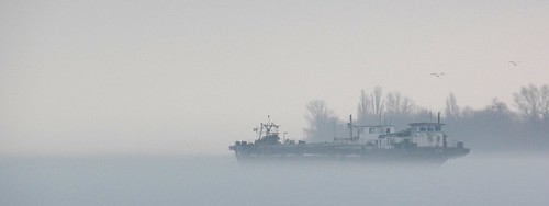 Ship in foggy frozen river