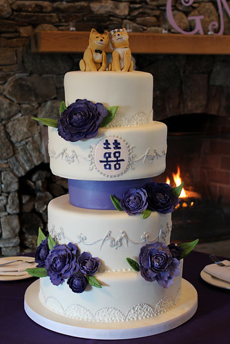 White and Silver Scrollwork Wedding Cake with Purple Sugar Flowers and Dog Toppers