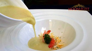 Asparagus soup with shrimps and egg dust