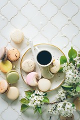 macarons beside teacup and ladle on round white ceramic plate - Credit to https://myfriendscoffee.com/